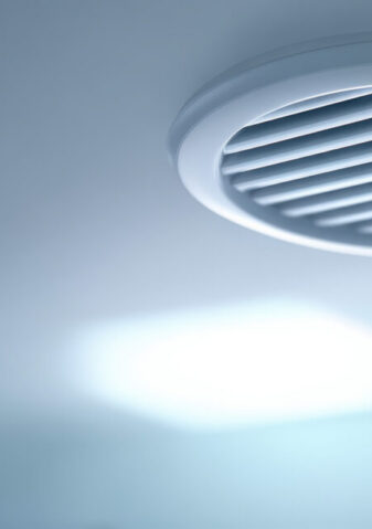 Clean modern interior ceiling with white ventilation vent or air diffuser. simple system for climate control creating calm and cool atmosphere in room